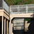 The new classroom building connects to an existing structure on the second level via a footbridge.